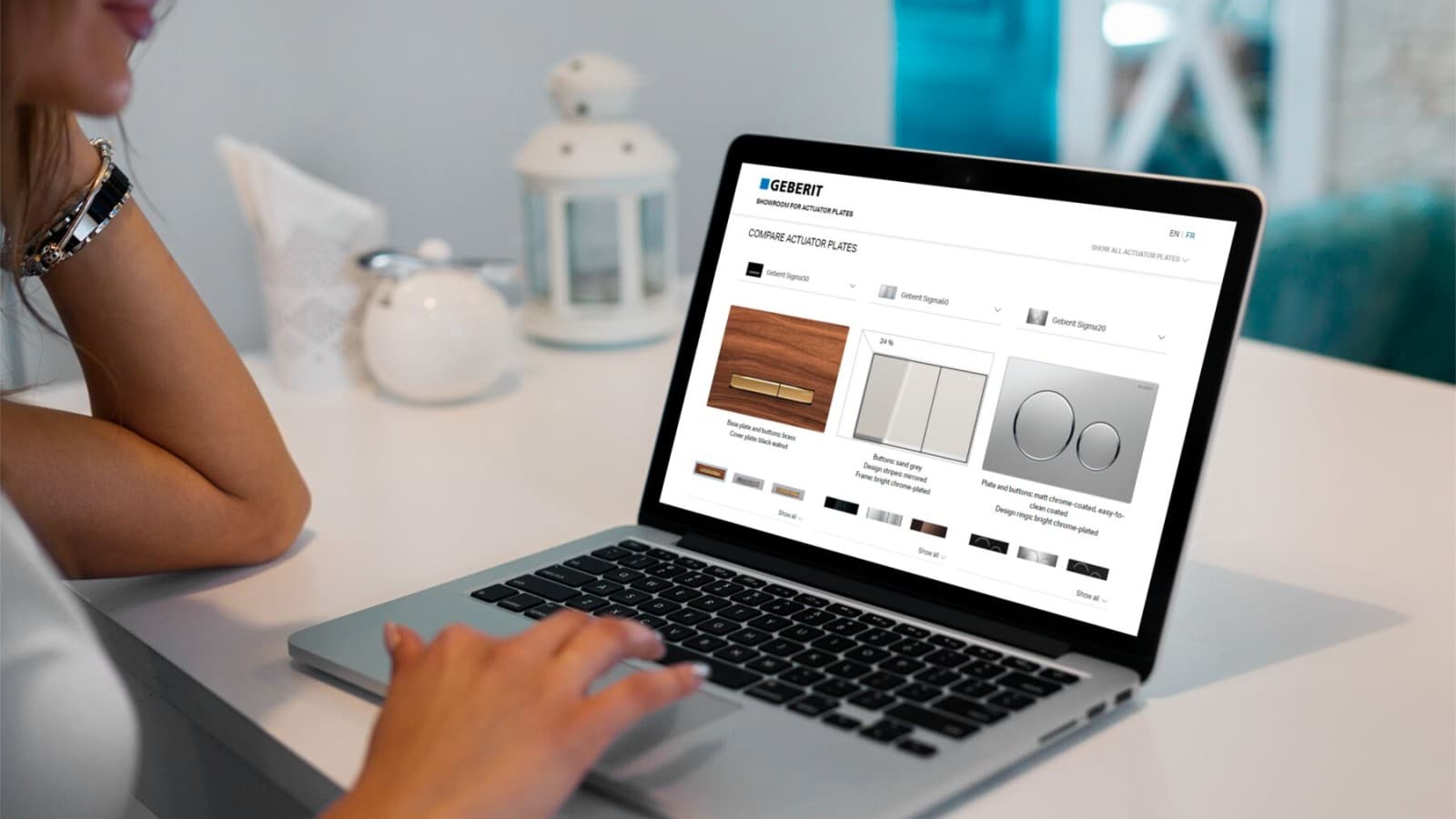 Ženska s prenosnim računalnikom odpre razstavni prostor aktivirnih tipk Geberit Ženska s prenosnim računalnikom odpre razstavni prostor aktivirnih tipk Geberit